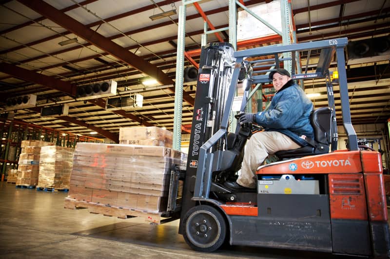 FORKLIFT-DRIVER-PALLET The inside of the Northern Refrigerated Transportation and Poppy State Express warehouse and crossdock, featuring pallets on a forklift.